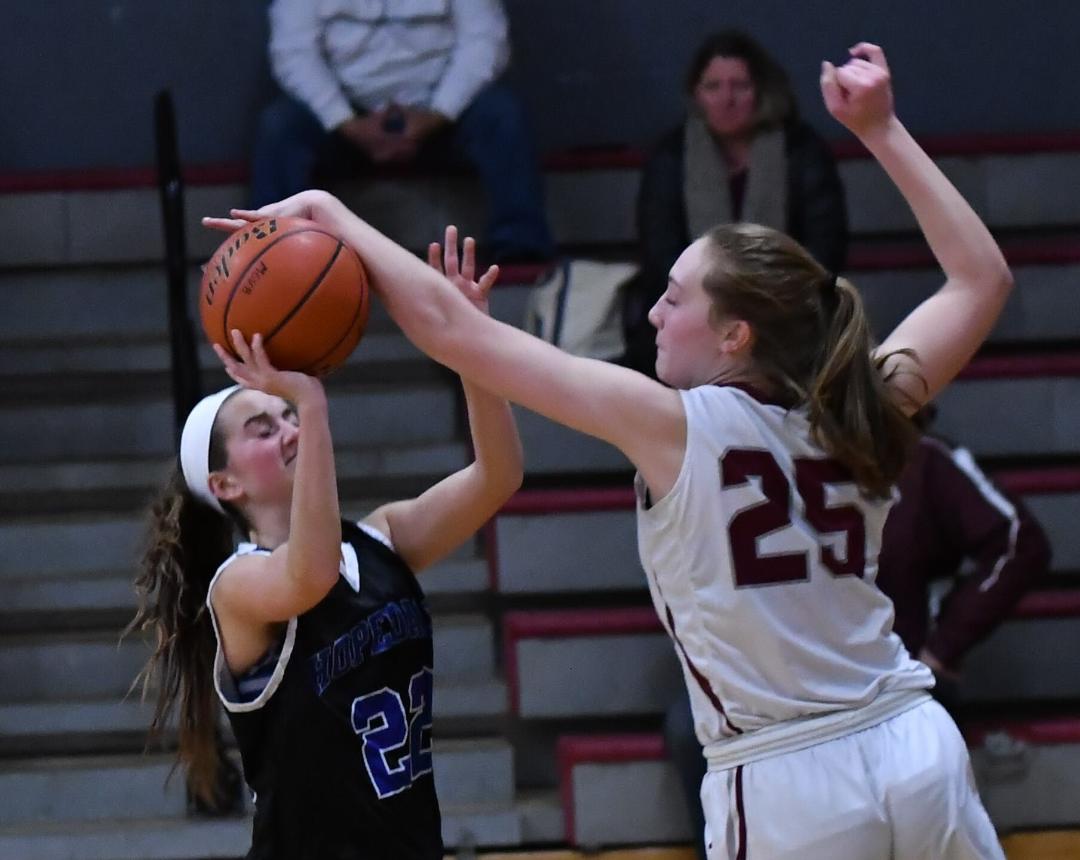 Abby Clark (No. 25), who provides a commanding presence in Millis’ frontcourt, blocks a shot against Hopedale. (Photo by STEVE BASSIGNANI)
