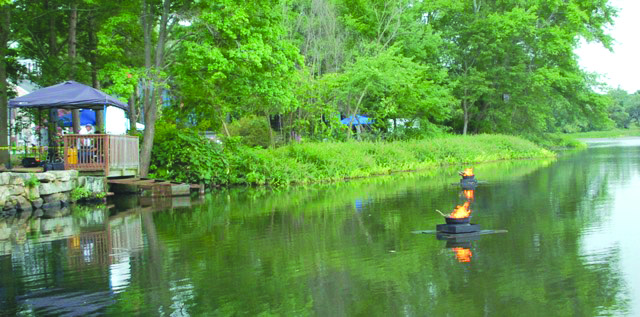 Floating fire adds a shimmering effect to Mill Pond and creates a unique ambiance for everyone at this outdoor festival.