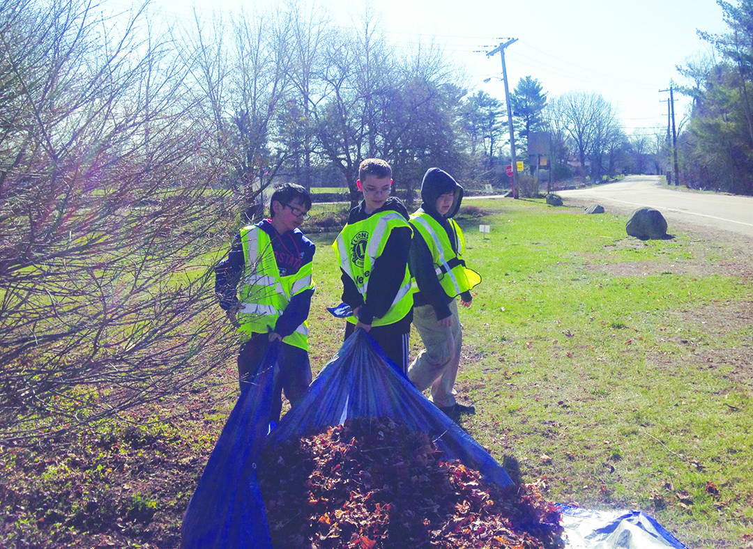 Each year, hundreds of town residents, including neighborhoods, friends, scouts and civic groups, participate in Millis Beautification Day. Shown, members of Millis Boy Scout Troop 15 spruce up an entrance point to the town.