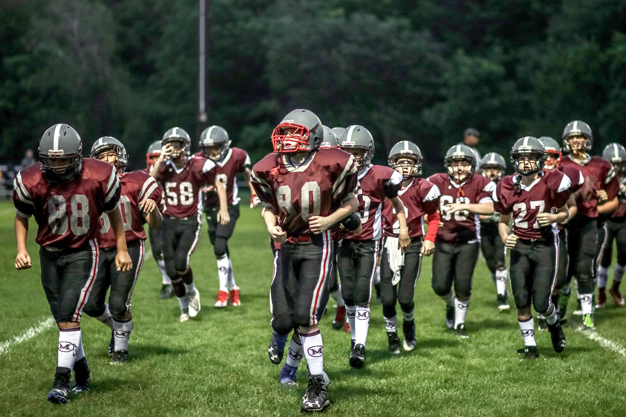 Shown are Millis middle school football players, who might one day play for the high school team. Brian Kraby, a teacher at Millis High School, is putting together a youth football and cheer program for even younger students, aged 9-12, in 4th, 5th and 6th grades, in the hopes of strengthening the town’s overall football program. Photo by Adriana Arguijo Photography