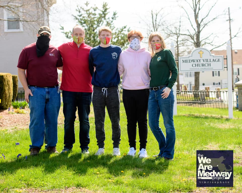 This photo by Tim Rice, was one of a Covid-19-era porch portrait endeavor that yielded $25,000 and 1,000 pounds of food for the two Medway food pantries (this includes a $5k donation from Medway Cable Access). From left to right, Fred Hopke, Martin Dietrich, Liam Dietrich, Aidan Dietrich, Susan Dietrich.